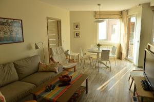 a living room with a couch and a table at Apartament Babitonga I in Puck