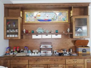 a kitchen with wooden cabinets and a stained glass window at Stella del Mare in Licata