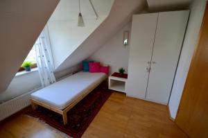 a small room with a bed and a window at Dachgeschosswohnung in Hannover