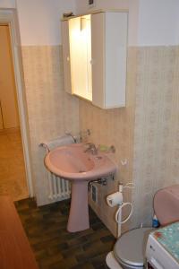 a bathroom with a pink sink and a toilet at Marimar in Antibes