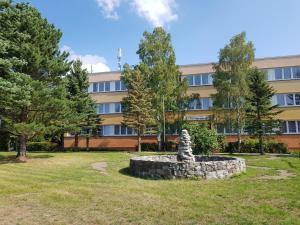 a stone statue in a park in front of a building at Hotel und Campingstell und Zeltplatz an der Talsperre im Harz in Altenbrak