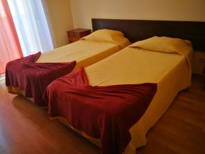 two beds sitting next to each other in a bedroom at Jardim Paraiso Apartments in Albufeira