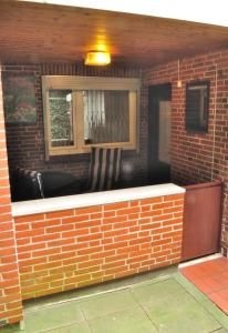 a brick wall with a bar in a building at Appartement Am Schulwald in Büsum