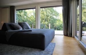 a bedroom with a bed and a large window at N8Quartier Chalet in Bad Münstereifel