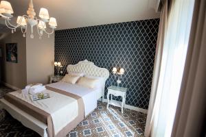 Voodi või voodid majutusasutuse Sui Generis Tropea Luxury Rooms toas