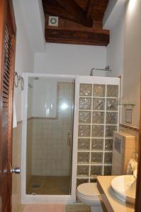 a bathroom with a shower, sink, and toilet at Gara Hotel in Garachico