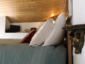 a bedroom with a bed with pillows on it at Douro Marina Studios in Vila Nova de Gaia