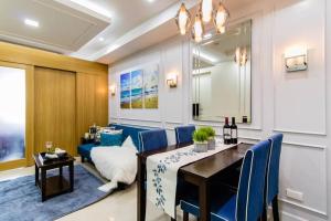 a dining room with a table and blue chairs at Shell Residence Manila in Manila