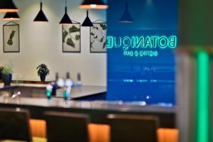 a bar in a restaurant with a blue wall at Botanique Hotel Prague in Prague