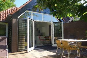 an extension to a house with sliding glass doors at B&B Achterom in Loon op Zand