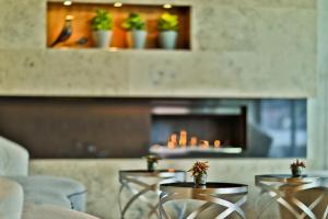 a restaurant with tables and chairs and a fireplace at Botanique Hotel Prague in Prague