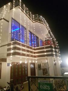 a building with christmas lights on it at night at SM Guest House in Lucknow