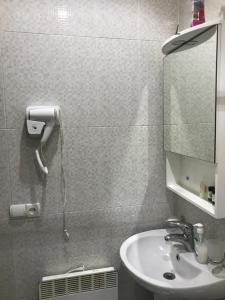 a bathroom with a sink and a mirror at LN'S APARTMENT in Borjomi