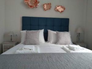 a bedroom with a large bed with towels on it at Petrani Suite 1 in Nea Peramos