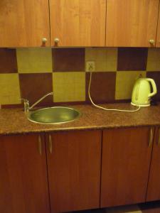 a kitchen counter with a sink and a telephone on it at Agroturystyka Pod Rumakiem in Chęciny