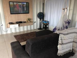 a living room with a couch and a hammock at Mandala House Container in Chapada dos Guimarães