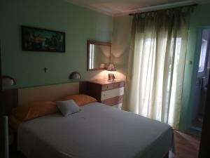 a bedroom with a white bed and a window at Guest House Tonica in Krk