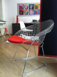 a chair with a red seat in a room at Holidaysuite Mathilda in Ostend