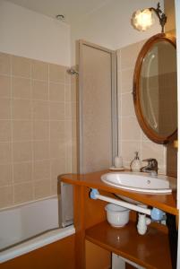 a bathroom with a sink and a mirror and a tub at La Valinière in Seur +21 photos