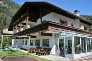 a house with a balcony on the side of it at Pension Pichler in Chienes