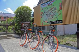 three bikes are parked in front of a building at Yufuin Tabinokura in Yufu