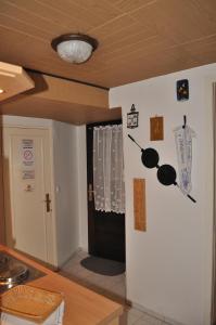 a kitchen with a wall with a clock on it at Appartement Am Schulwald in Büsum