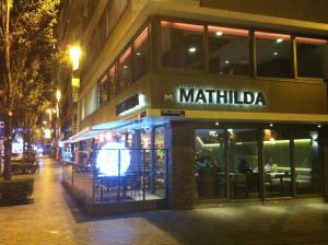 a restaurant on a city street at night at Holidaysuite Mathilda in Ostend