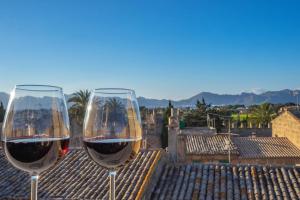 two glasses of wine sitting on top of a roof at Casa López in Alcudia