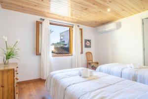 a hotel room with two beds and a window at Casa López in Alcudia