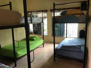 a room with three bunk beds in a room at La Terraza Hostel in Flores