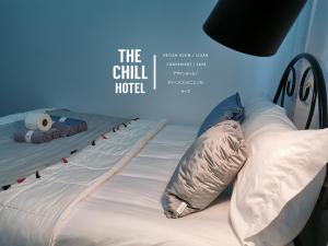 a bed in a room with a sign that reads the chill hotel at The Chill Town Home in Maha Sarakham