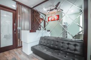 a black leather couch in a waiting room at Super OYO 1487 Residence Khoe in Jakarta