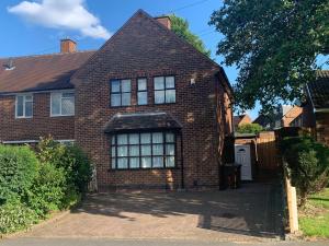 a red brick house with a driveway at Sunny Garden WFH Retreat with Private Entrance and Parking near NEC BHX JLR in Solihull