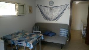 a room with a bed and a table and a window at Casa Pamela in Noto Marina