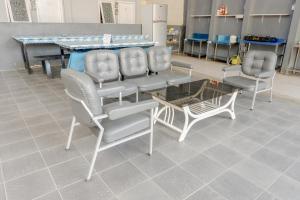 a group of chairs and a table in a room at Super OYO Capital O 1176 J3 Residence Syariah in Jember