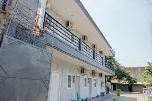 a building with a balcony on the side of it at Super OYO Capital O 1176 J3 Residence Syariah in Jember