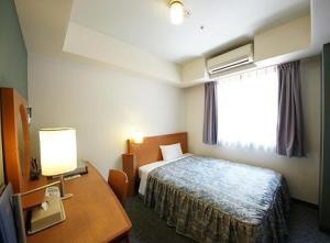 Postel nebo postele na pokoji v ubytování Hotel Landmark Nagoya