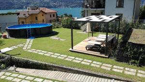 a backyard with a swimming pool and a gazebo at Villa Mari in Dervio