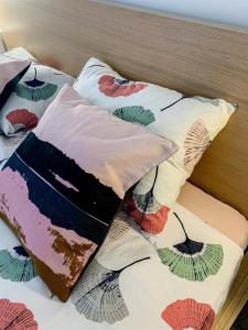 a bed with colorful pillows on top of it at Apartments Milena 8 in Mandre