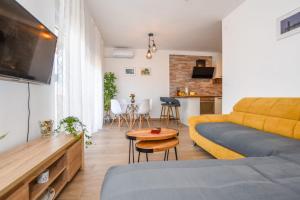 a living room with a couch and a table at Apartments Milena 8 in Mandre