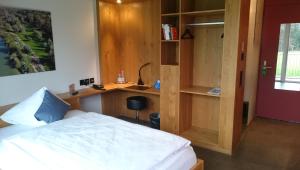 a bedroom with a bed and a desk in it at Hotel Frauenfeld in Frauenfeld