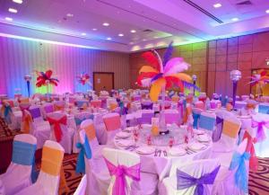 a large banquet hall with white tables and chairs at Riverdale Hotel in Kandy