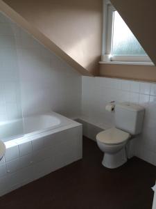 a bathroom with a toilet and a bath tub at Rooms by No2 Troon Road in Troon