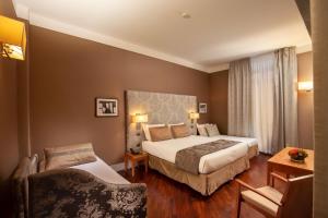 A bed or beds in a room at Monti Palace Hotel