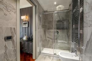 a bathroom with a shower and a sink at Monti Palace Hotel in Rome