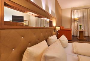 A bed or beds in a room at Angerhof Sport- u. Wellnesshotel