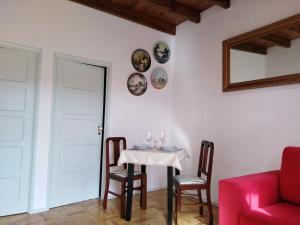 a dining room with a table and chairs and a mirror at Quinta dos Capuchos Casa da Adega in Alcobaça