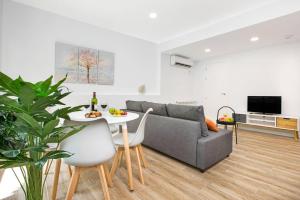 a living room with a couch and a table at Stay U-nique Apartments Fabra i Puig in Barcelona