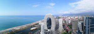 an aerial view of a city with the ocean at ORBi CITY TOWERS in Batumi