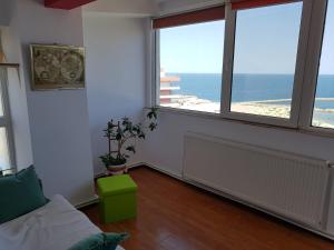 a living room with a view of the ocean at Faleza Nord Sea View Apartment in Constanţa